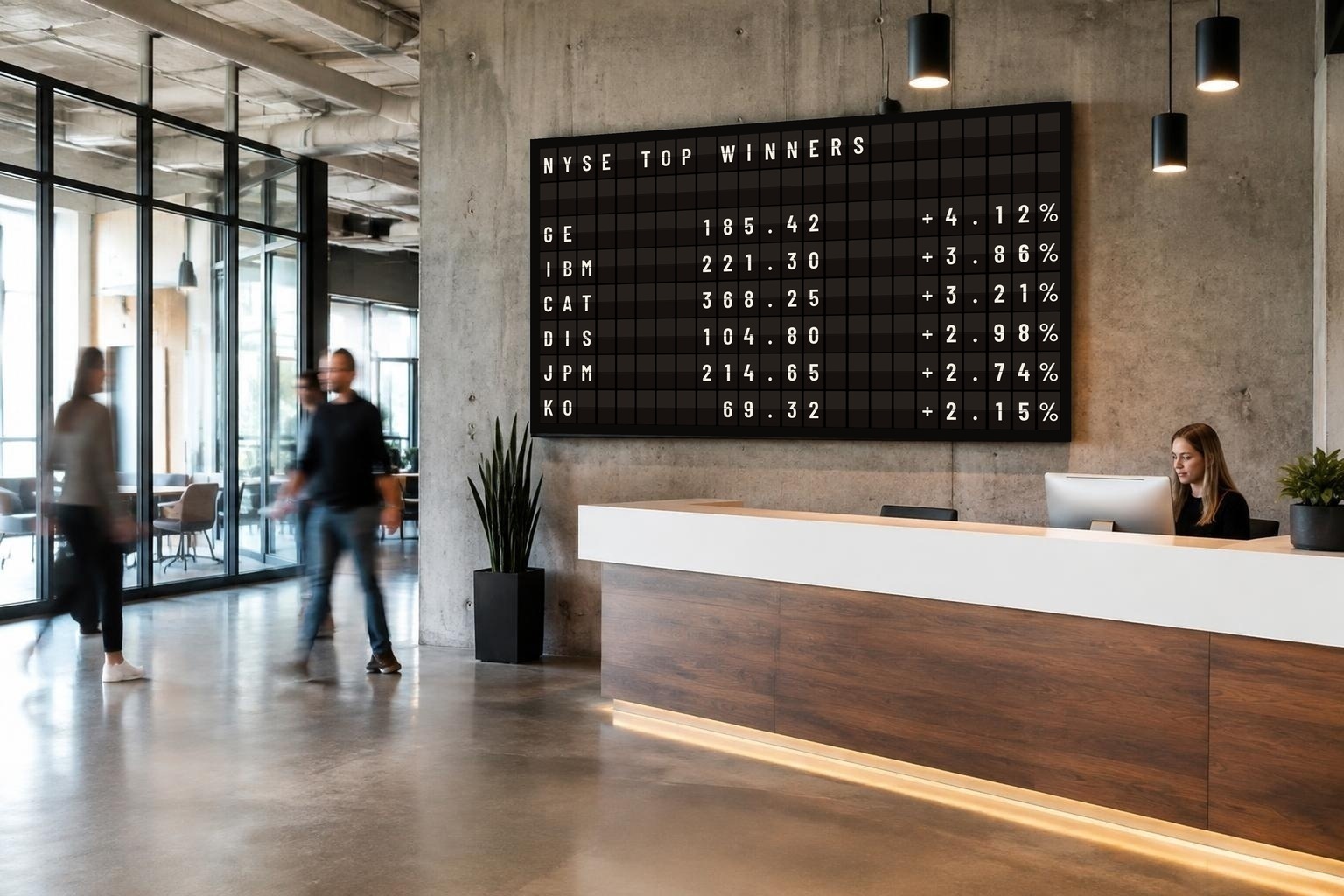 Dark-theme KarmaBoard split-flap digital signage showing NYSE stock winners in a modern office lobby